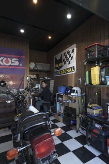 ご主人念願のビルトインガレージ、床の市松模様のシートはご主人自ら施工。愛車はKAWASAKI のZ-400J。「高校生の頃からバイクが好きで。時間があればいじっています。リビングからもバイクが見えるのが最高！」とご主人。